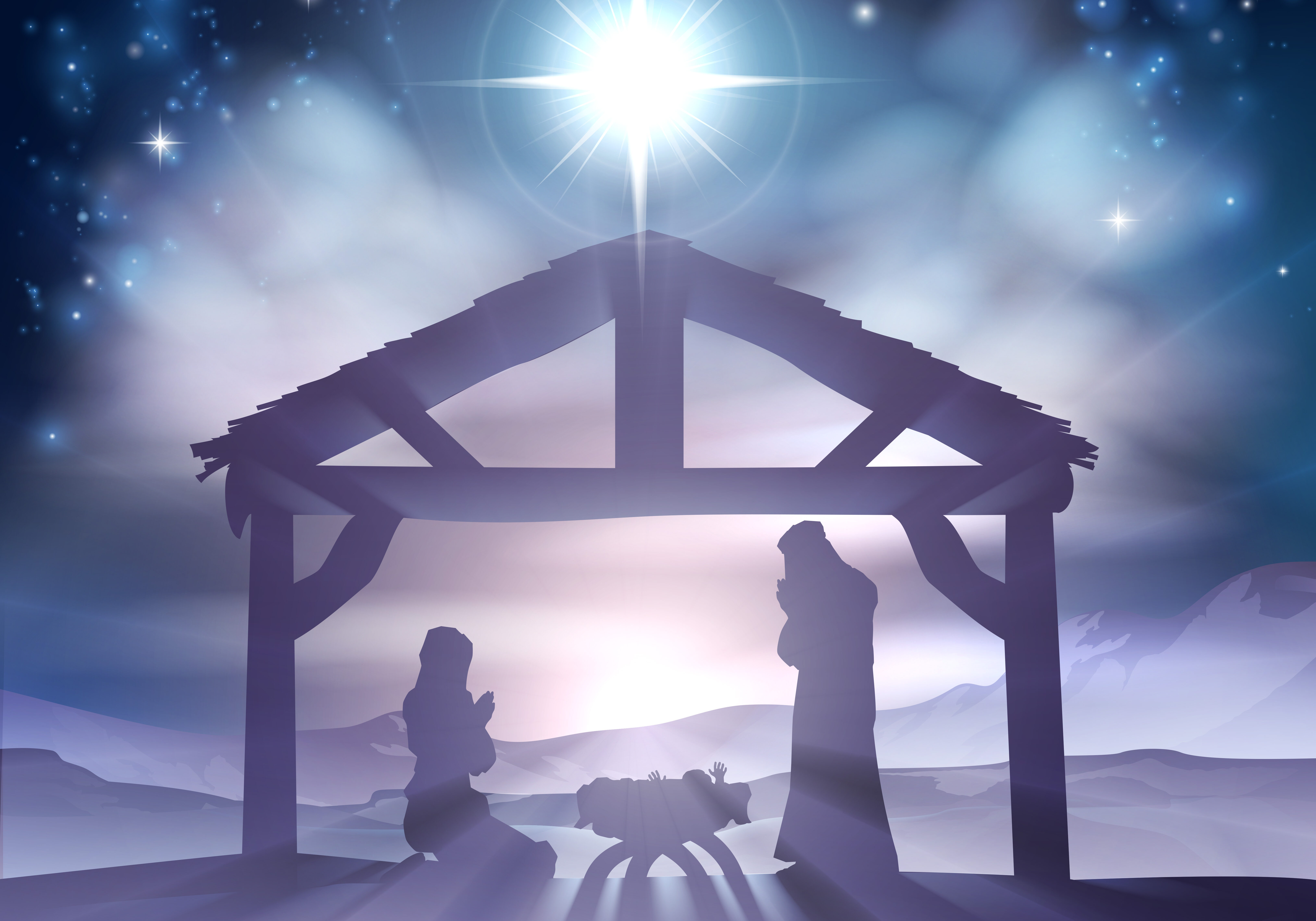 Traditional Christian Christmas Nativity Scene of baby Jesus in the manger with Mary and Joseph in silhouette