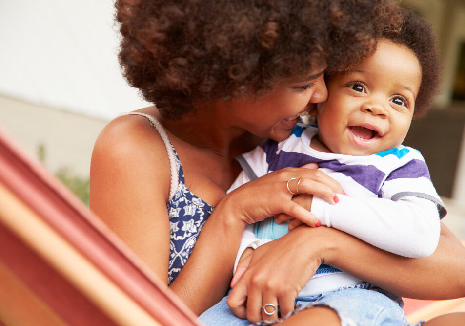 Mother bonding with young son sitting in a hammock