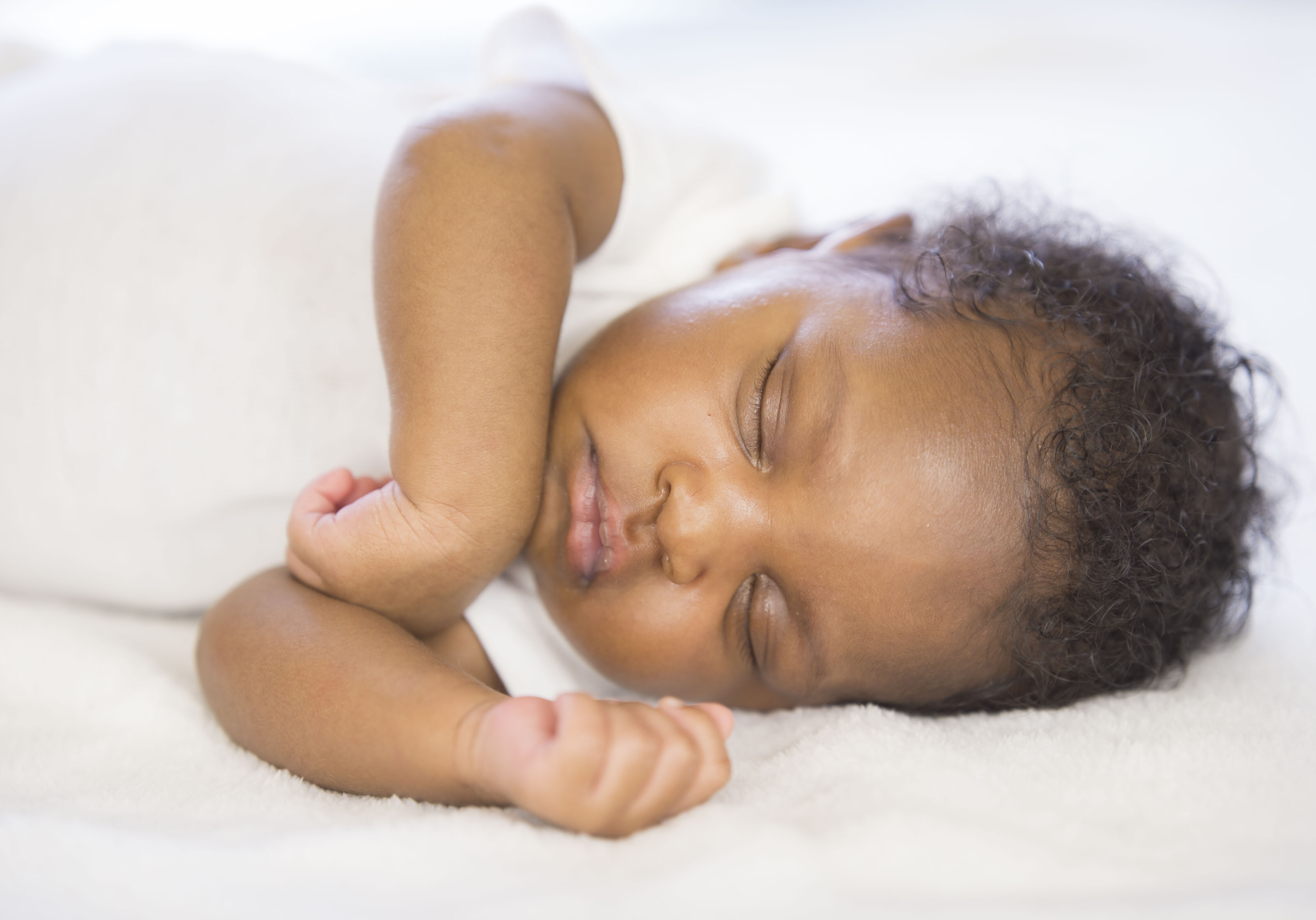 Mother cuddling with her newborn baby in the living room